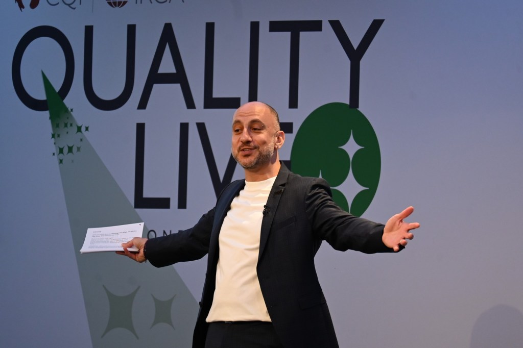 Rashad Issa speaking on stage at Quality Live 2026
